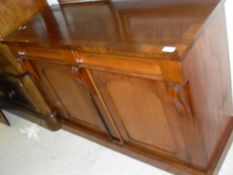 A Victorian mahogany chiffonier with two drawers over two cupboard doors on a plinth base
