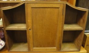 An early 20th Century Heals oak hanging wall cabinet,