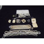 A collection of costume jewellery to include various pearl necklaces, hard stone set brooch,