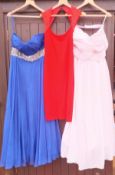 A collection of three evening dresses, one by St.