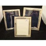 A collection of three modern silver photograph frames with beaded edge decoration (by Carrs of