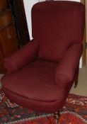 A pair of circa 1900 burgundy upholstered scroll arm chairs on turned legs to castors