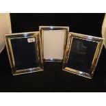 A pair of modern silver photograph frames with reeded and ribbon decoration (stamped "925",