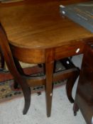 A Regency mahogany dining table raised on square tapering legs with additional leaf