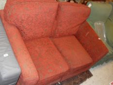 A Kirkdale red foliate upholstered two seat sofa