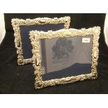 A pair of modern silver photograph frames with C scroll and floral embossed decoration (by Carrs of