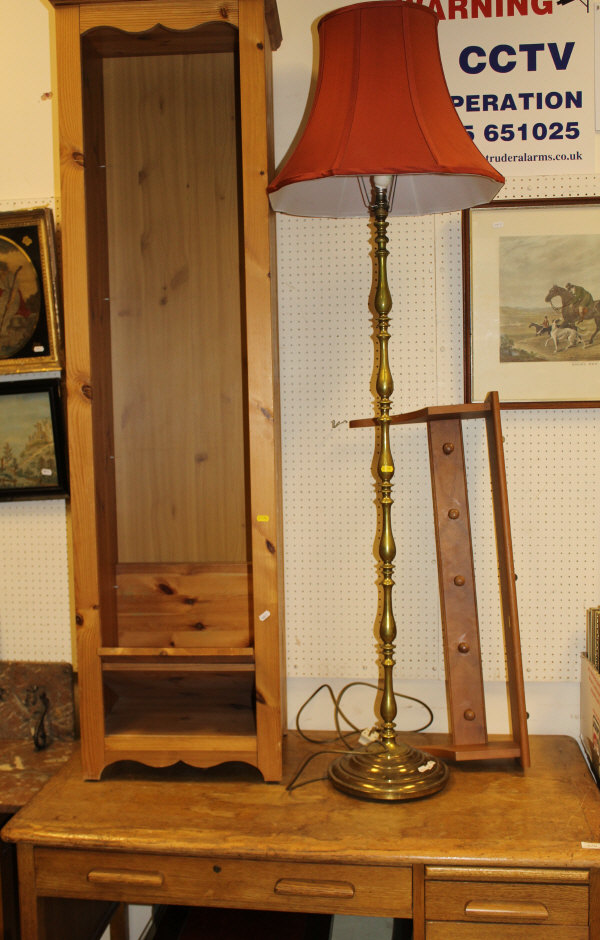 A modern brass turned standard lamp and red shade,