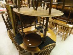 A Danish circular extending dining table together with a set of four stick back chairs in the Ercol