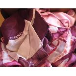 A box containing a Gucci pale pink scarf, a Dior silk scarf, a Gucci floral decorated silk scarf,