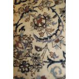 A Persian rug, the central panel set with a central circular medallion on a cream ground,