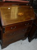 A mahogany inlaid and cross banded bureau of three drawers to bracket feet