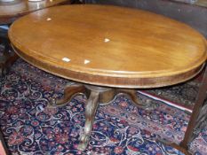 A Victorian mahogany oval centre table on turned column to four cabriole legs on china castors