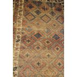 A Caucasian rug, the central panel set with repeating diamond pattern on a neutral ground,