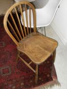 A set of four elm seated stick back chairs, a circa 1900 walnut wall cabinet,