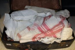 A box containing assorted textiles to include table linen,