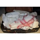 A box containing assorted textiles to include table linen,