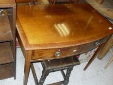 A mahogany and cross-banded bow front two drawer side table on square sectioned tapering legs,