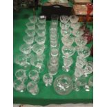 A collection of various drinking glassware to incldue a set of twelve etched glass champagnes,