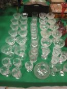 A collection of various drinking glassware to incldue a set of twelve etched glass champagnes,
