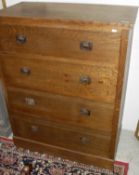 A circa 1900 oak chest of four long drawers with iron ring handles in the Arts and Crafts taste