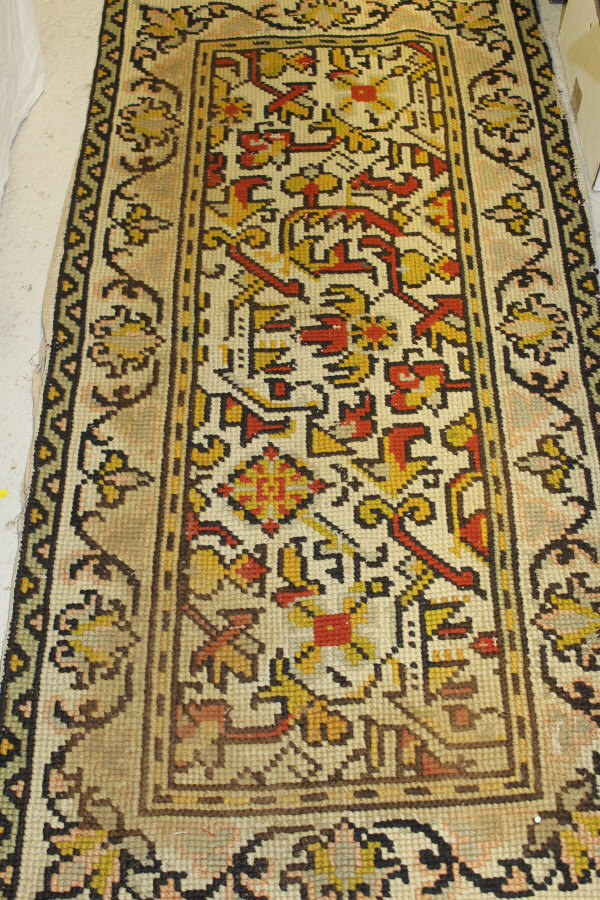 A Persian rug, the central panel set with stylised floral medallion on a red, blue and cream ground, - Image 2 of 34