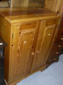 A 20th Century pine two door cupboard enclosing adjustable shelves,