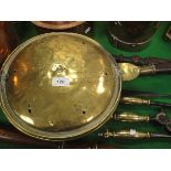 An 18th Century brass bed pan with pierced and engraved decoration bearing indistinct maker's stamp,