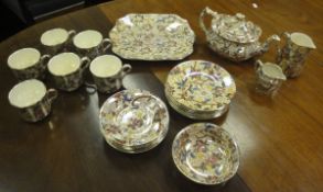 A Maling transfer decorated blossom and mottled print lustre ware part tea service