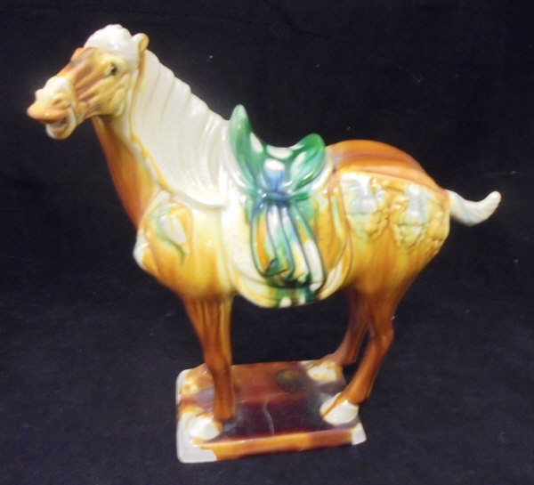 A 20th Century polychrome glazed pottery horse figure in the Tang dynasty manner bearing raised and