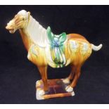 A 20th Century polychrome glazed pottery horse figure in the Tang dynasty manner bearing raised and