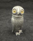 A 19th Century pewter pounce pot in the form of an owl with glass eyes