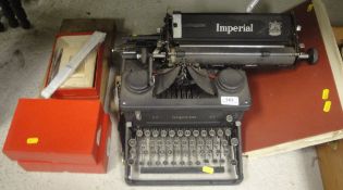 An Imperial 55 manual typewriter, together with two boxes of ribbons, a Victorian photograph album,