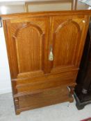 A circa 1900 satinwood cabinet the two cupboard doors enclosing various shelves and filing drawers