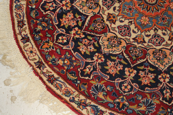 A Persian rug, the central panel set with stylised floral medallion on a red, blue and cream ground, - Image 9 of 34