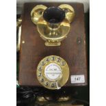 A wall-mounted wooden cased telephone based on the GPO 121 phone with solid brass fittings