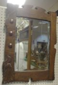 A circa 1900 oak framed and copper mounted Arts & Crafts style wall mirror with bevel edged plate,