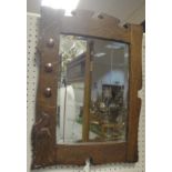 A circa 1900 oak framed and copper mounted Arts & Crafts style wall mirror with bevel edged plate,
