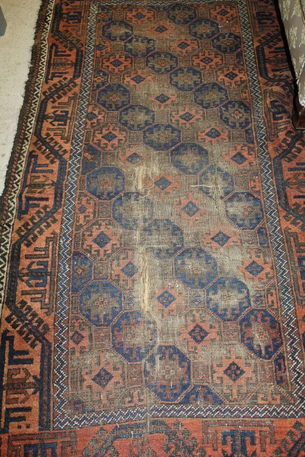 A Caucasian rug, the centre field with repeating hexagonal medallions in terracotta, - Image 2 of 3