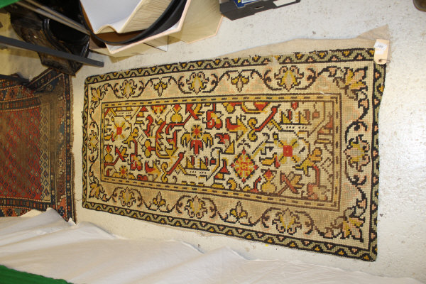 A Persian rug, the central panel set with stylised floral medallion on a red, blue and cream ground, - Image 18 of 34