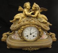 A 19th Century gilt metal cased mantle clock with porcelain panels depicting cherubs amongst clouds,