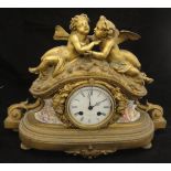 A 19th Century gilt metal cased mantle clock with porcelain panels depicting cherubs amongst clouds,