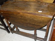An early 20th Century oak oval gate-leg drop-leaf dining table in the the 17th Century manner,