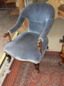 A Victorian walnut framed open arm salon chair,