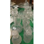 A set of three cut glass decanters with collared necks and stoppers,