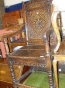 An oak wainscot carver chair with shaped swan neck pediment and diamond carved panelled back,