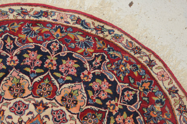 A Persian rug, the central panel set with stylised floral medallion on a red, blue and cream ground, - Image 6 of 34
