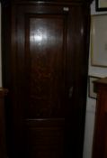 A 19th Century oak hanging corner cupboard with twin fielded panelled door enclosing four shelves