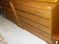 Two oak effect bedroom chests of two short over three long drawers to bracket feet