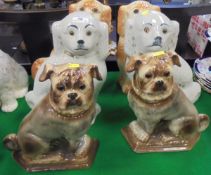 A pair of circa 1900 Staffordshire glazed pottery figures of pugs with glass eyes and two pairs of