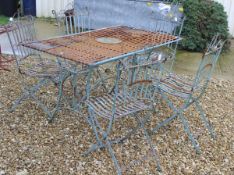 A green painted iron garden table and five chairs